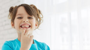Girl smiling with missing tooth