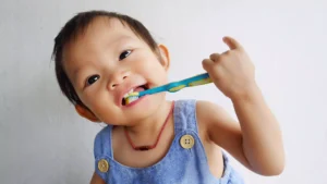 smiling-baby-with-toothbrush
